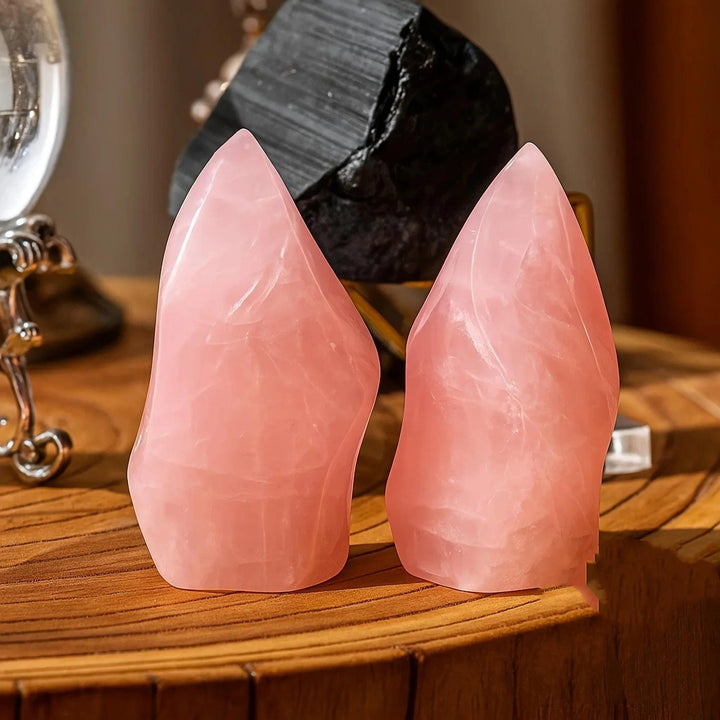 Two polished, soft pink Rose Quartz crystal torch towers with tapered points and flat bases.