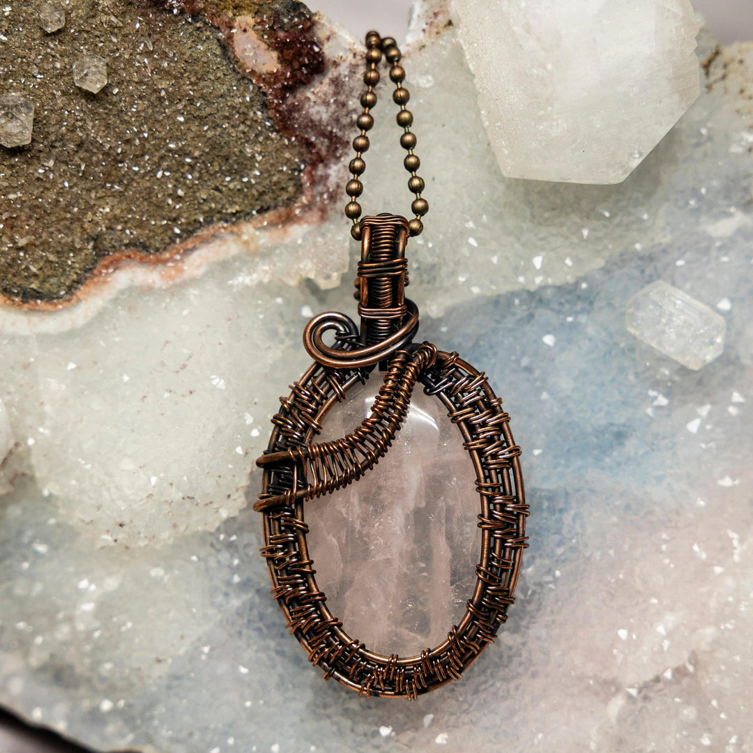 Rose Quartz Wire Wrap Pendant, 2.5" handcrafted in healing copper wire, showcasing its soft translucent pink.