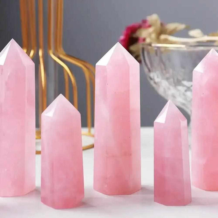 Polished rose quartz hexagonal crystal points in soft pink, perfect for Heart Chakra healing and home decor.