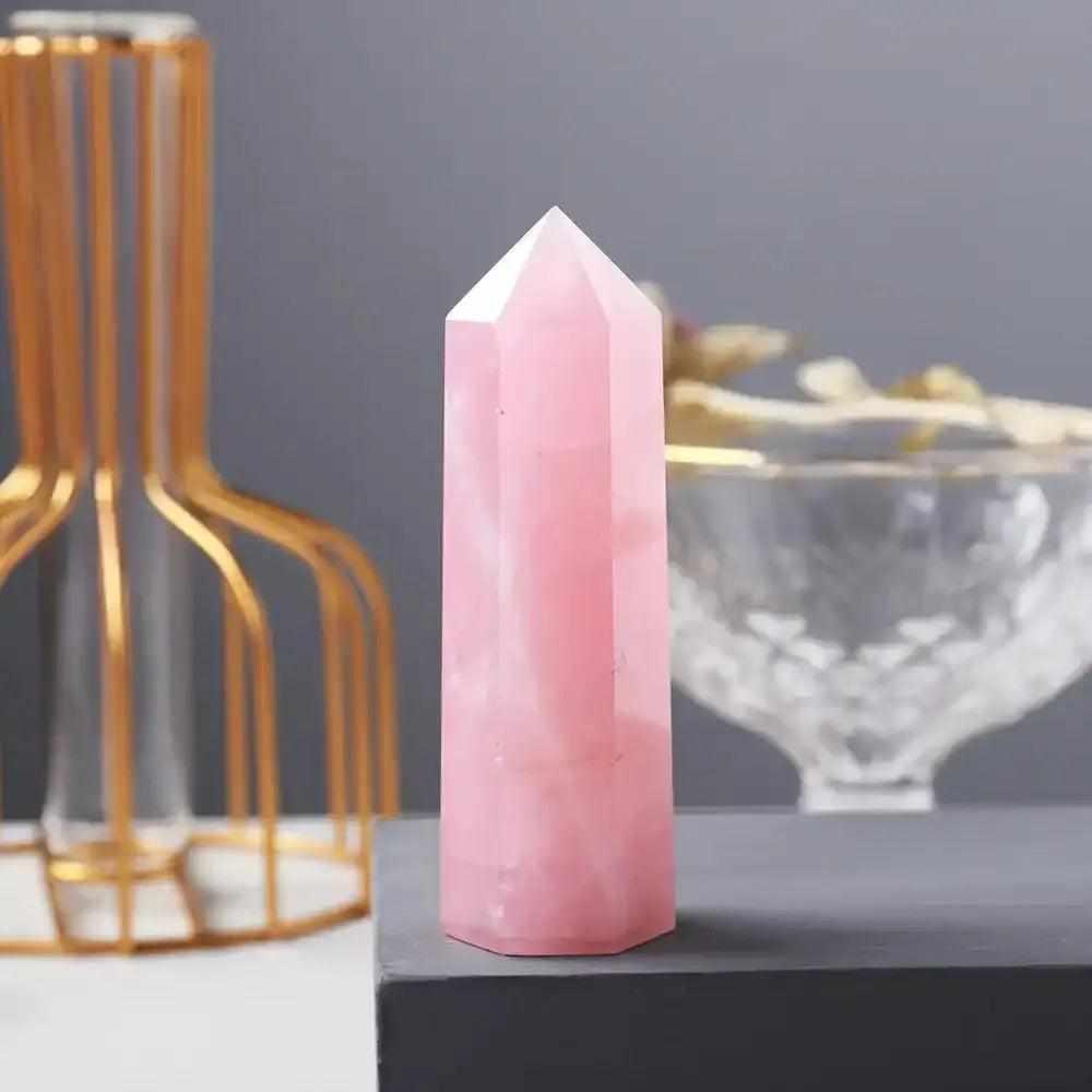 Polished rose quartz hexagonal crystal point in soft, milky pink, perfect for Heart Chakra healing and home decor.