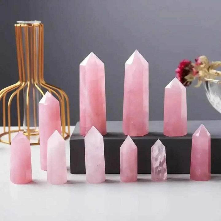 Polished rose quartz hexagonal crystal points in various sizes for heart chakra healing and unconditional love.