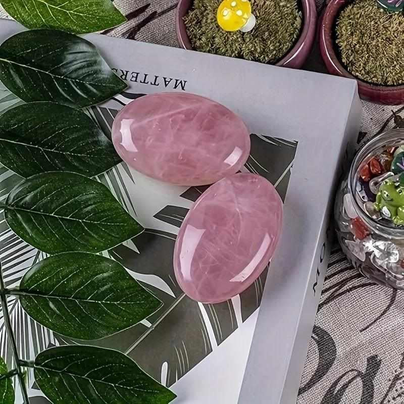 Two smooth, polished rose quartz palm stones in soft pink, perfect for heart chakra meditation and self-love rituals.