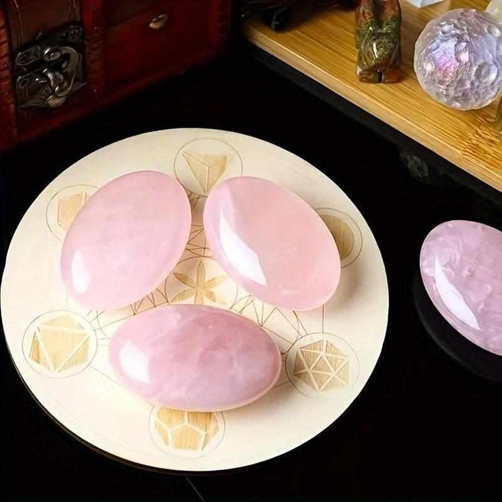 Smooth, pale pink Rose Quartz palm stones with a polished oval finish, perfect for Heart Chakra meditation and healing.