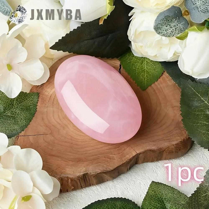 Smooth, oval Rose Quartz palm stone in soft pink, perfect for heart chakra meditation and self-love rituals.