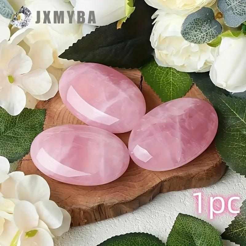 Three smooth, polished rose quartz palm stones in soft pink, perfect for heart chakra meditation and self-love.