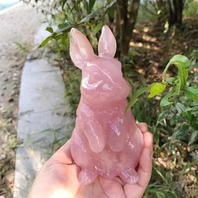 Hand-carved Rose Quartz rabbit figurine by Crystal Destiny, showcasing soft pink hues and a smooth polished finish.