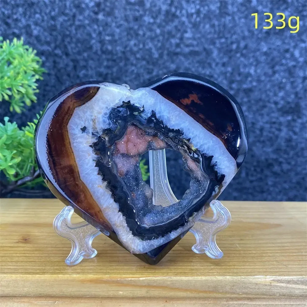Heart-shaped black and red agate geode with sparkling crystal cave, 133g, for home decor.