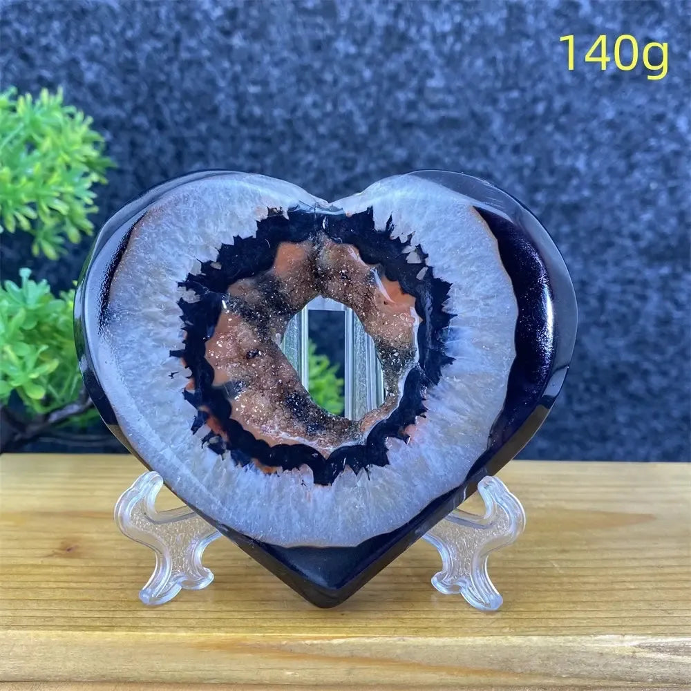 Heart-shaped black and red agate geode with sparkling crystal cave, 140g, for home decor.