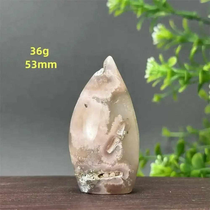 Polished Sakura Agate torch freeform with soft pink cherry blossom patterns, perfect for Heart Chakra healing and decor.