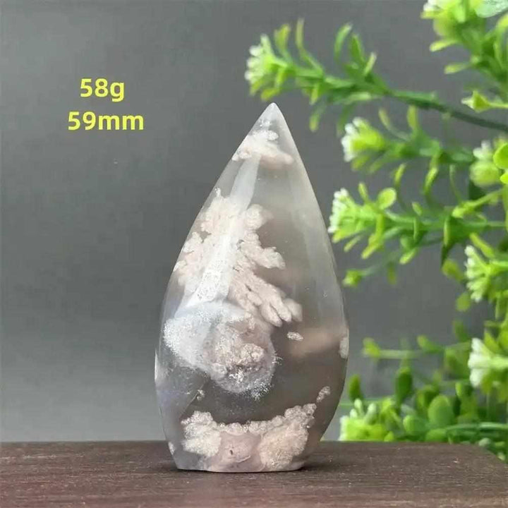 Polished Sakura Agate torch freeform with soft pink cherry blossom patterns, ideal for Heart Chakra healing and decor.