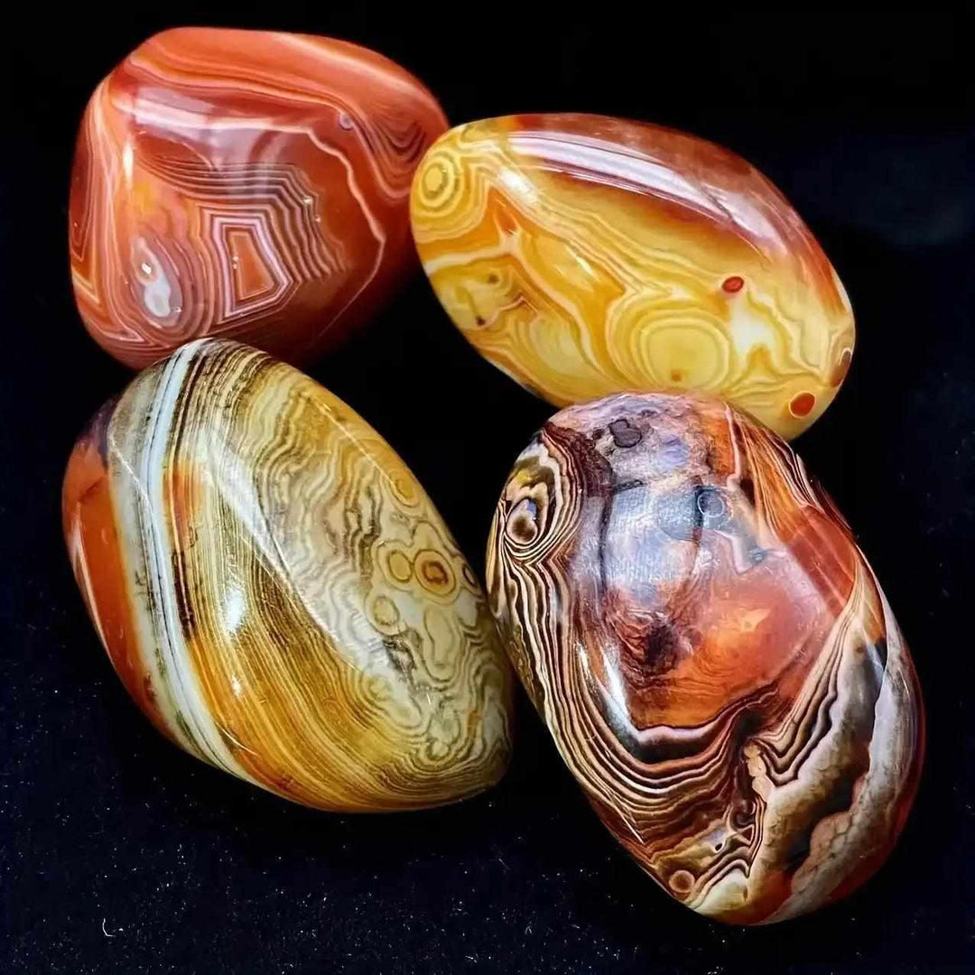 Polished Sardonyx palm stones featuring natural reddish-brown, honey, and white bands for grounding and strength.