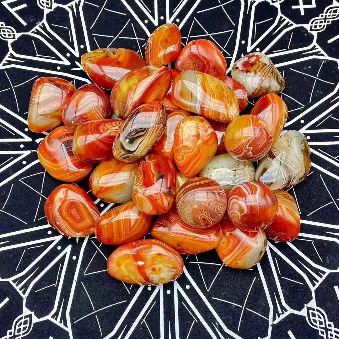Polished sardonyx palm stones featuring vibrant reddish-brown, honey, and white bands for grounding and strength.
