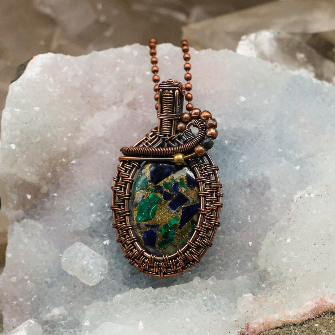 Sea Sediment Jasper Wire Wrap Crystal Pendant #2: Handcrafted copper wire wraps a unique oval stone with swirling ocean blue, seafoam green, and gold patterns for tranquility and emotional balance.
