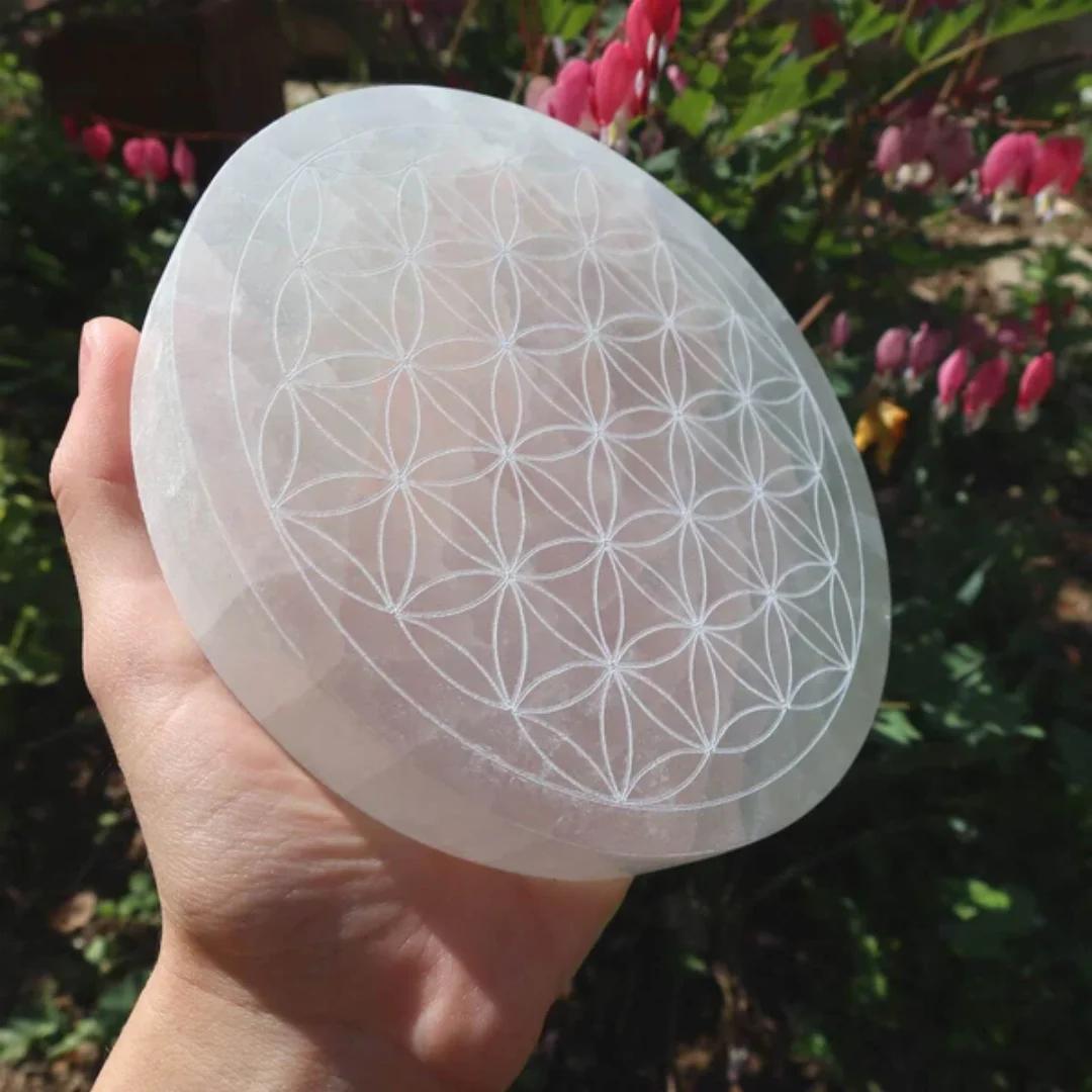 Selenite Crystal Carved Flower of Life Charging Plate, a white, oval, self-cleansing crystal for purification and peace.