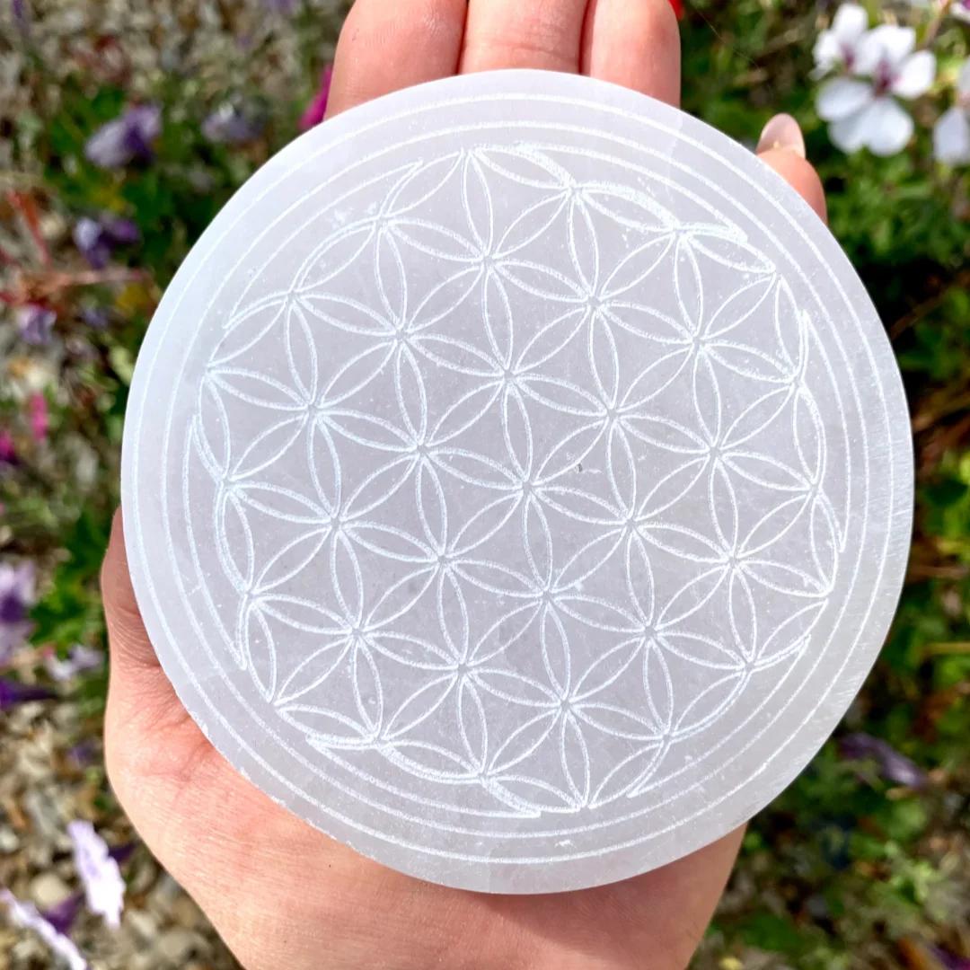 Selenite Crystal Carved Flower of Life Charging Plate, a white, round, sacred geometry crystal for clearing and lifting energy.