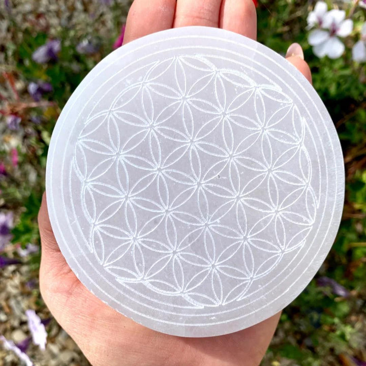 Selenite Crystal Carved Flower of Life Charging Plate, a white, round, sacred geometry crystal for clearing and lifting energy.