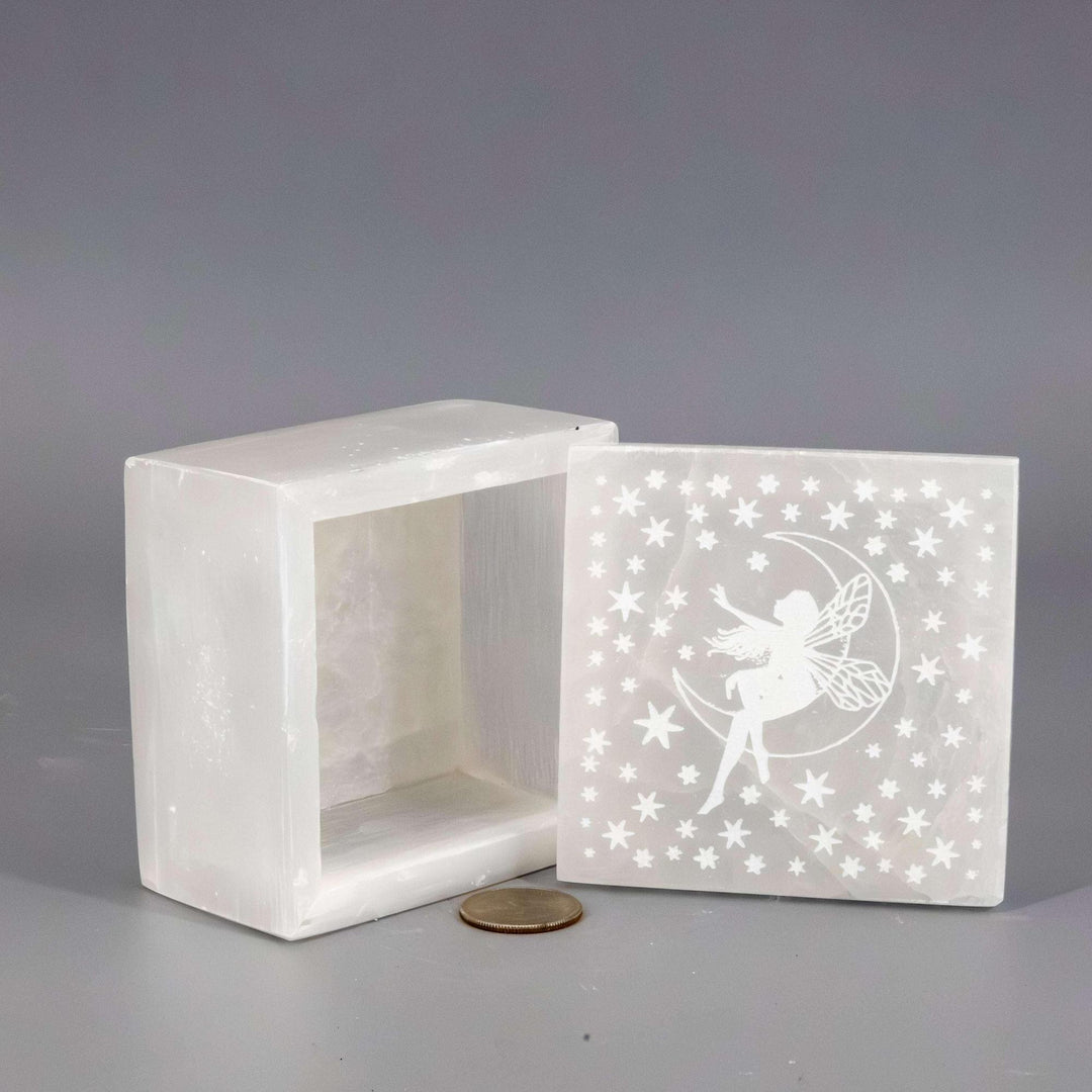 Selenite "Forest Fairy" Jewelry Box: pearlescent white crystal box with a carved fairy on a moon, surrounded by stars.