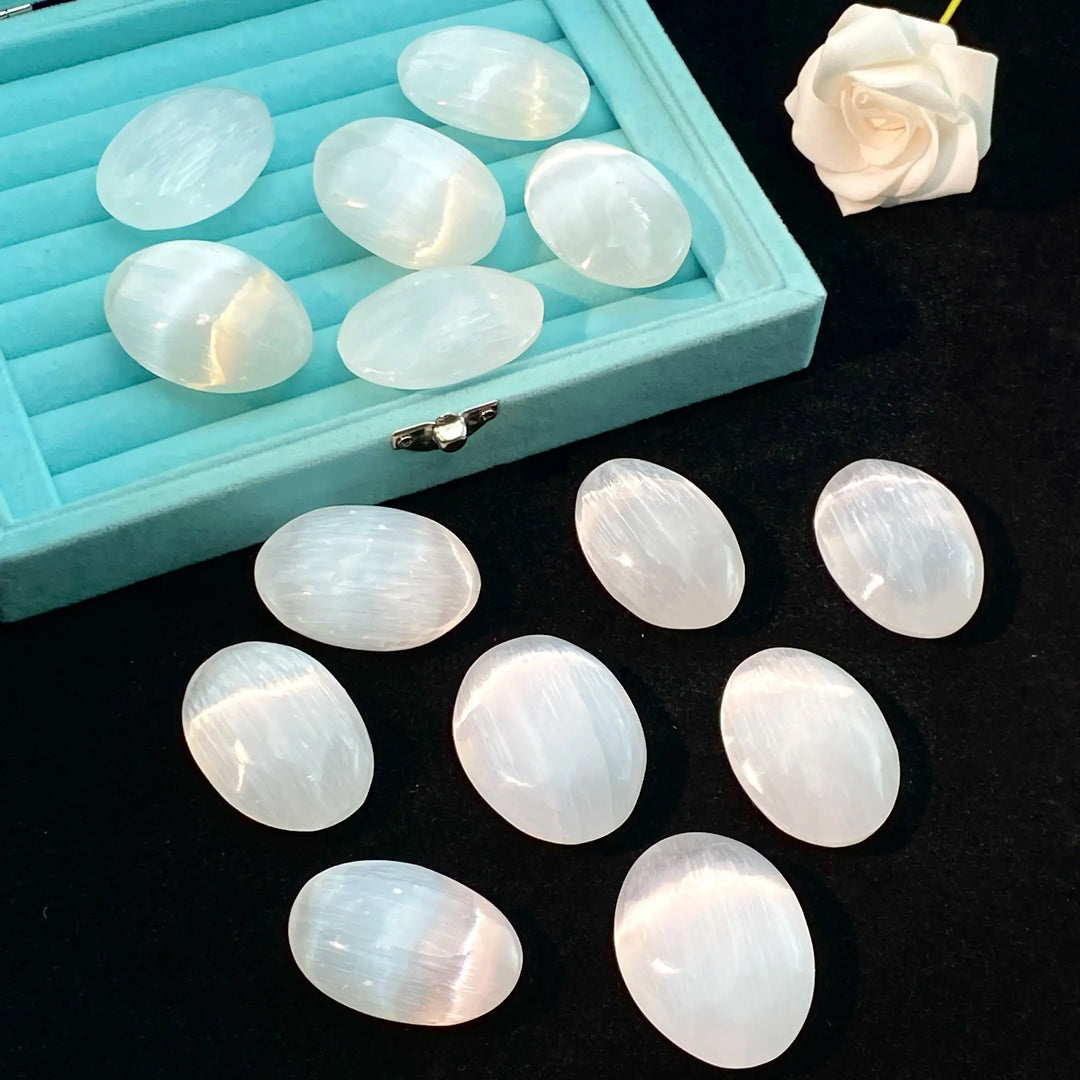Polished natural Selenite palm stones with a luminous white glow, perfect for healing, meditation, and elegant home decor.