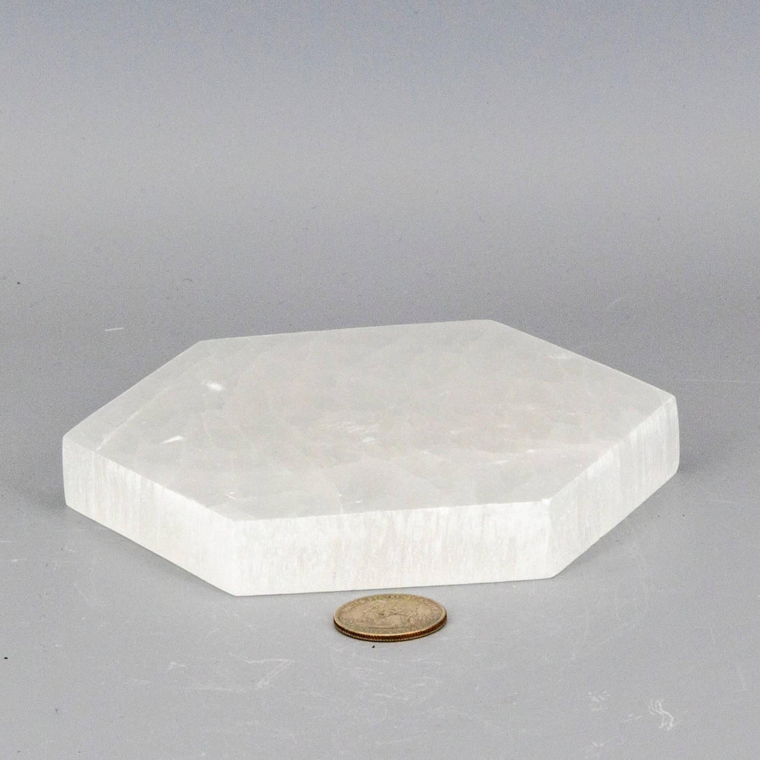 Selenite Hexagonal Charging Plate: thick, polished white selenite in a precise hexagonal form, clearing and recharging crystals.
