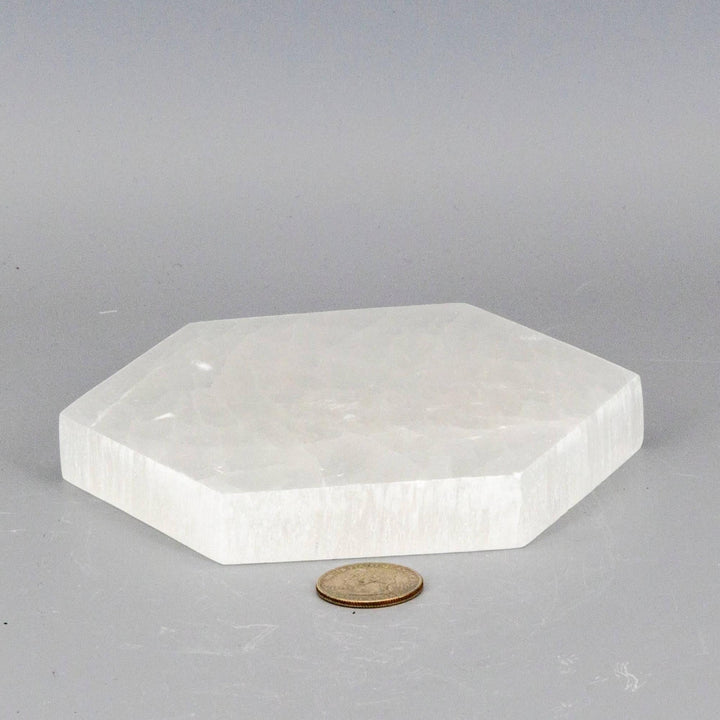 Selenite Hexagonal Charging Plate: thick, polished white selenite in a precise hexagonal form, clearing and recharging crystals.