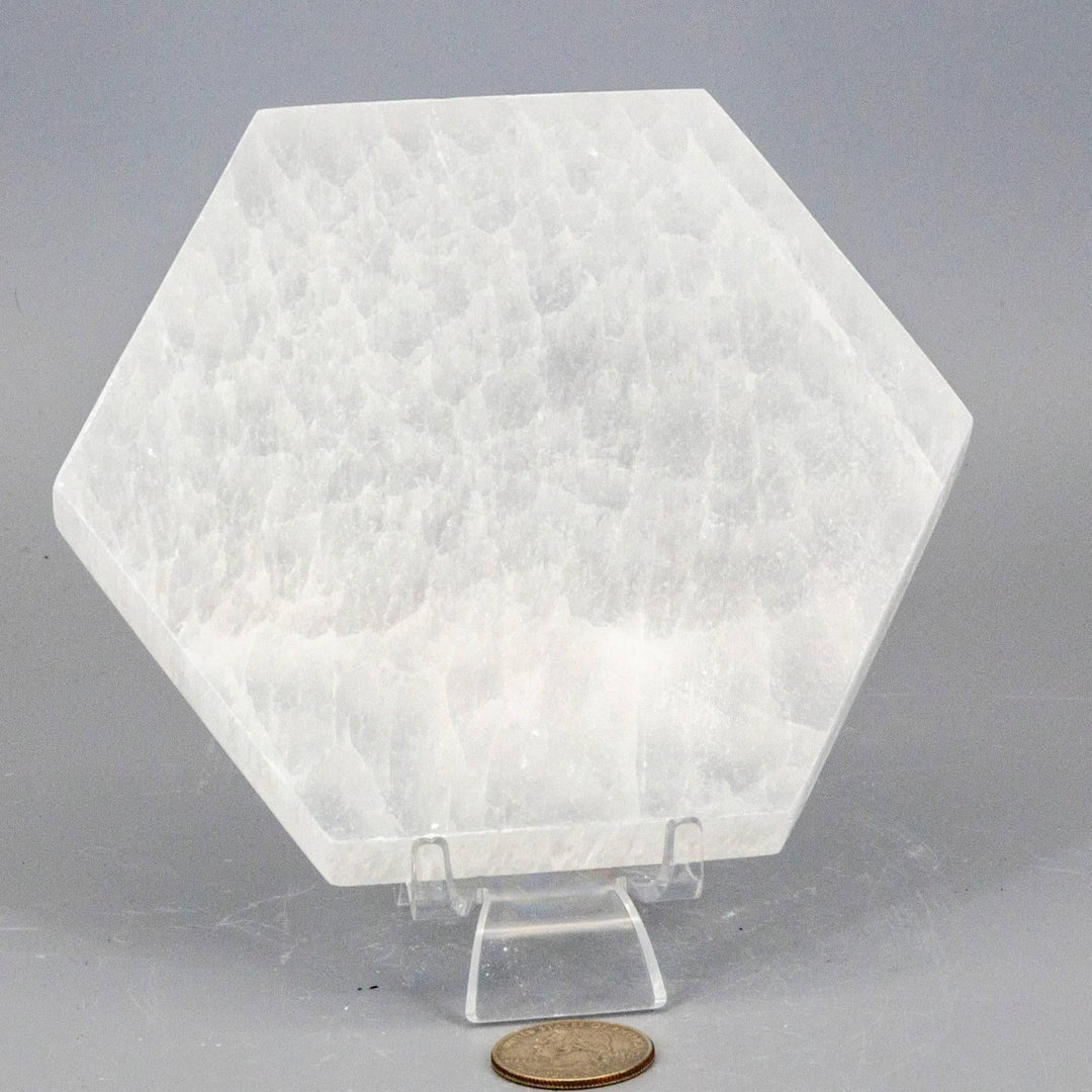 Thick, polished white Selenite Hexagonal Charging Plate, radiating clearing energy for crystals and jewelry.