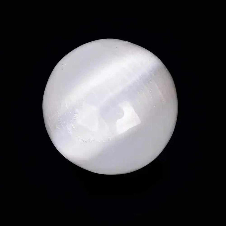 Polished white Selenite crystal sphere with a silky, glowing sheen for peaceful energy and Crown Chakra cleansing.
