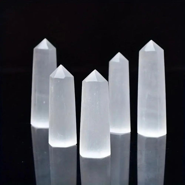 Luminous white Selenite crystal hexagonal towers for meditation, cleansing energy, and spiritual crown chakra healing.