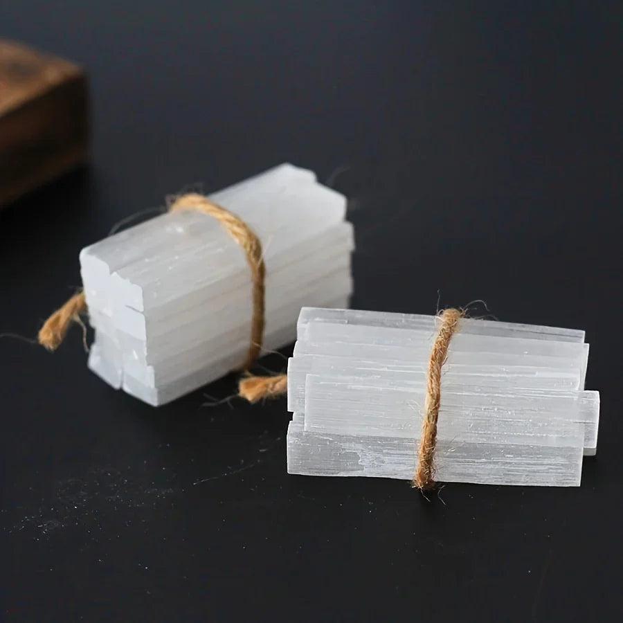 Natural Selenite Crystal Wands: raw, white gypsum sticks bundled with twine, ideal for cleansing and meditation.