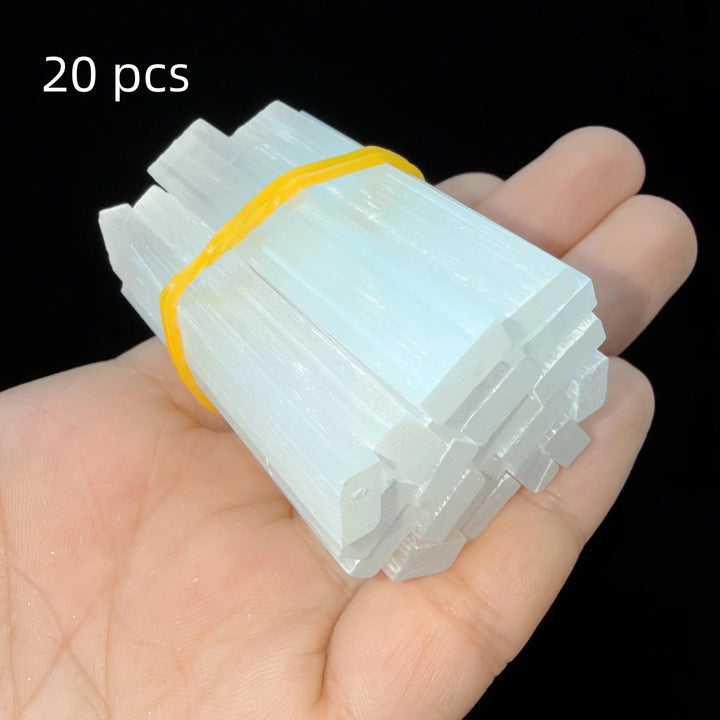 Hand holding a bundle of 20 natural white Selenite Crystal Wands, raw gypsum sticks for cleansing and meditation.