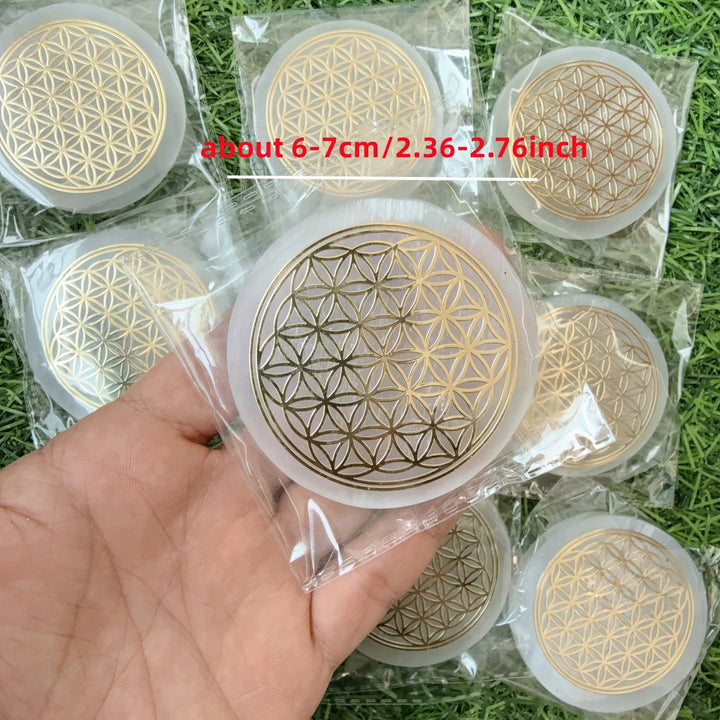 Selenite Flower of Life Crystal Charging Plate Slab, a white fibrous gypsum disk with a gold sacred geometry design.