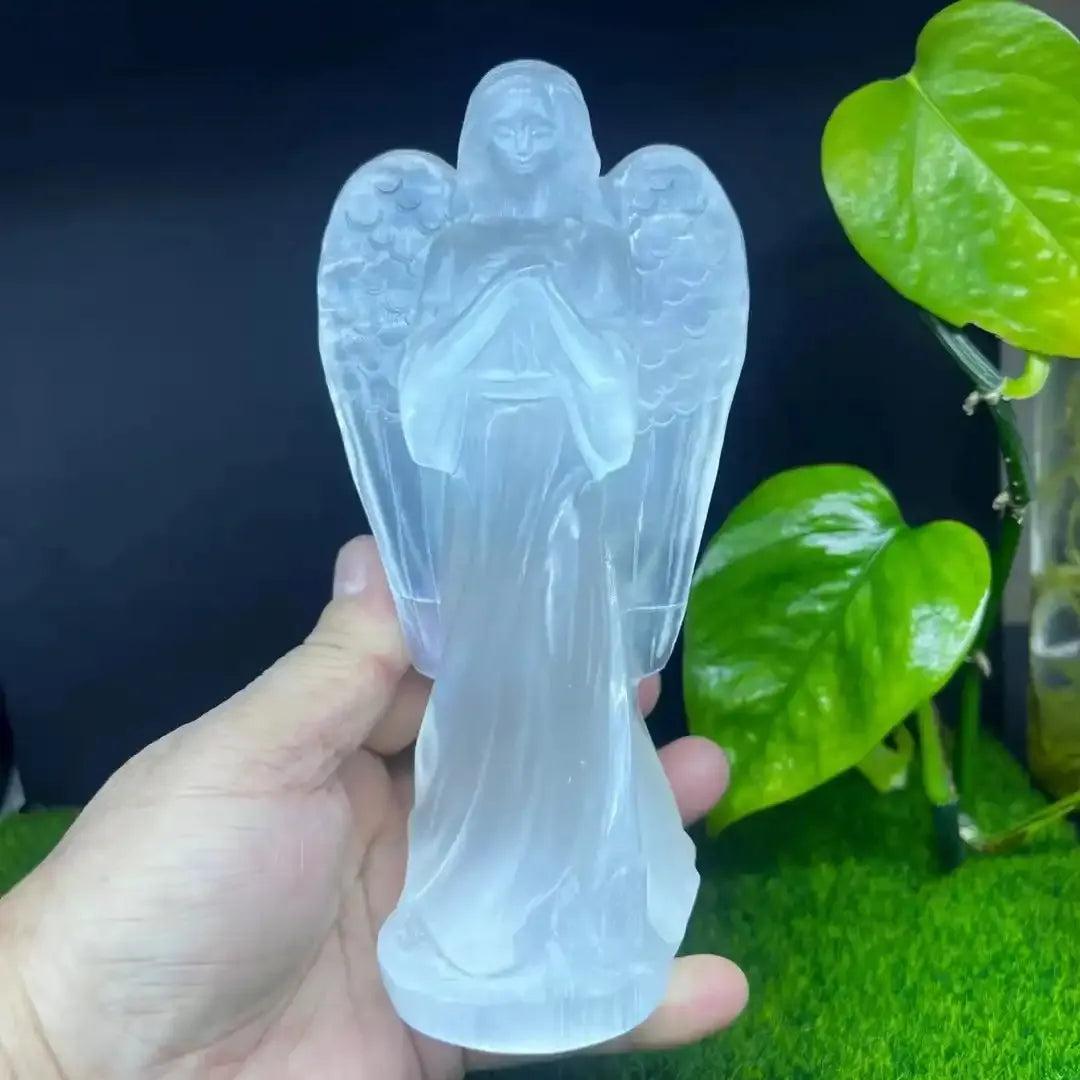 Hand carved white selenite guardian angel figurine, a translucent healing crystal stone for peaceful home decor.