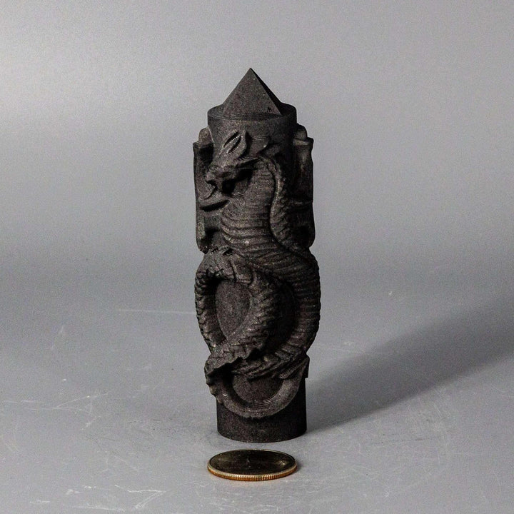 Dark Shungite CNC Carved Dragon Tower, 4" tall, with intricate scales and a powerful presence, beside a coin.