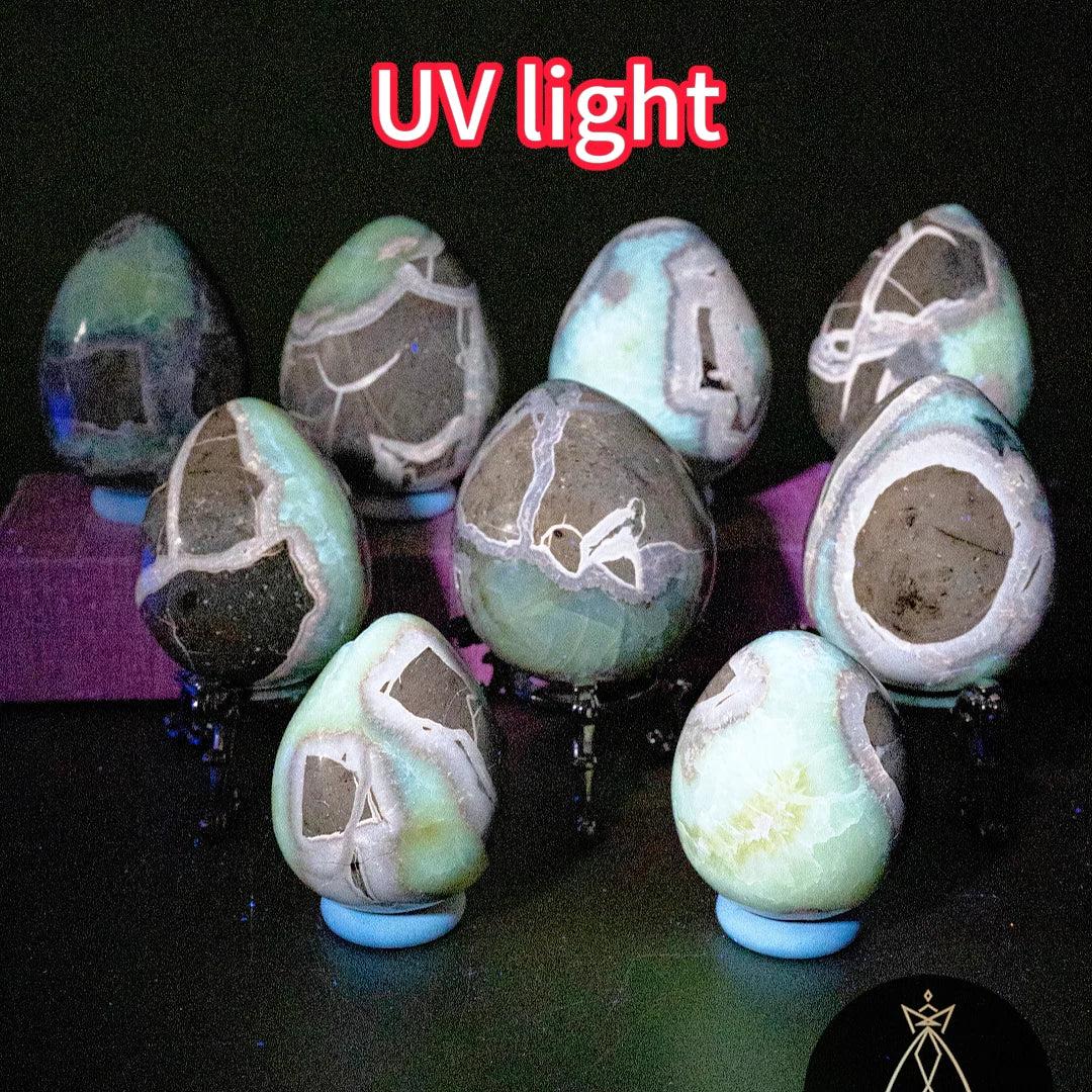 Septarian Crystal Egg Natural Dragon Stone Geode Egg under UV light, revealing striking green, black, and white patterns.