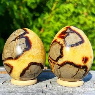 Septarian Crystal Egg: Natural Dragon Stone Geode Egg with striking yellow calcite and dark aragonite patterns.