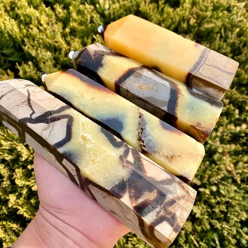 Septarian Stone Crystal Tower: Hand-polished hexagonal obelisks with warm ochre, deep chocolate, and grey calcite patterns.