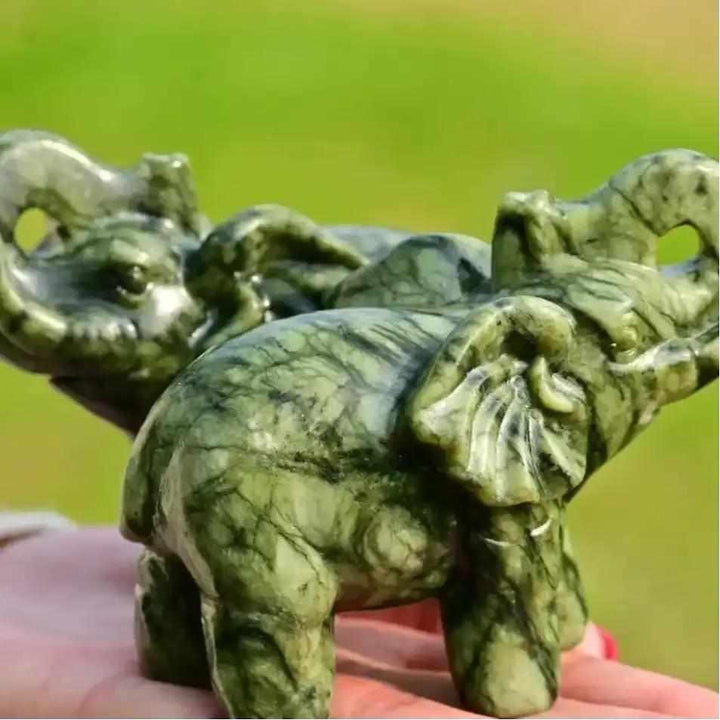 Polished 50mm Serpentine Elephant carving in soft green stone, a symbol of strength for Heart and Crown Chakra healing.