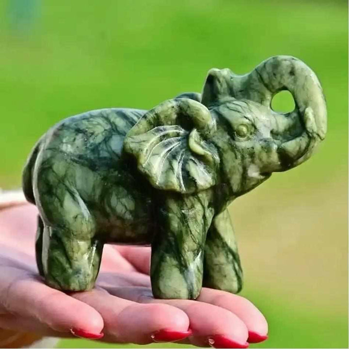 Polished 50mm Serpentine Elephant carving in soft green stone, a symbol of strength for Heart and Crown Chakra healing.