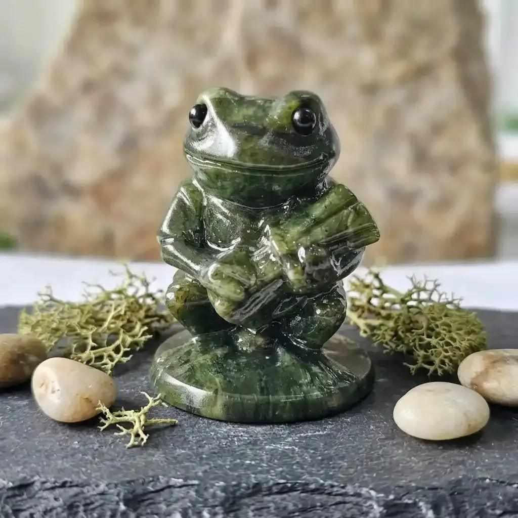 Hand-carved serpentine frog figurine in polished deep green stone, perfect for Heart Chakra balance and desk decor.