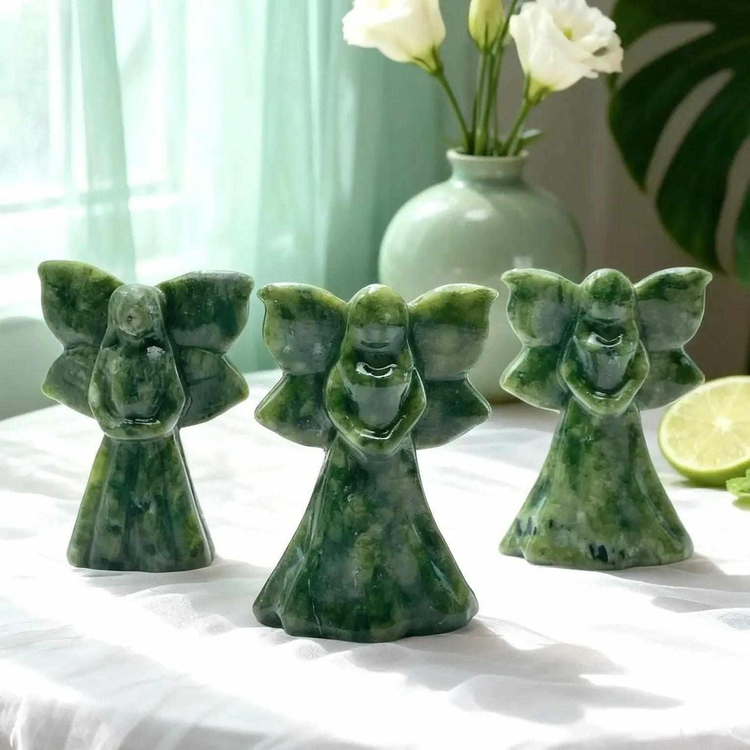 Three luminous green Xiuyan Jade angel carvings, promoting calm and emotional balance.