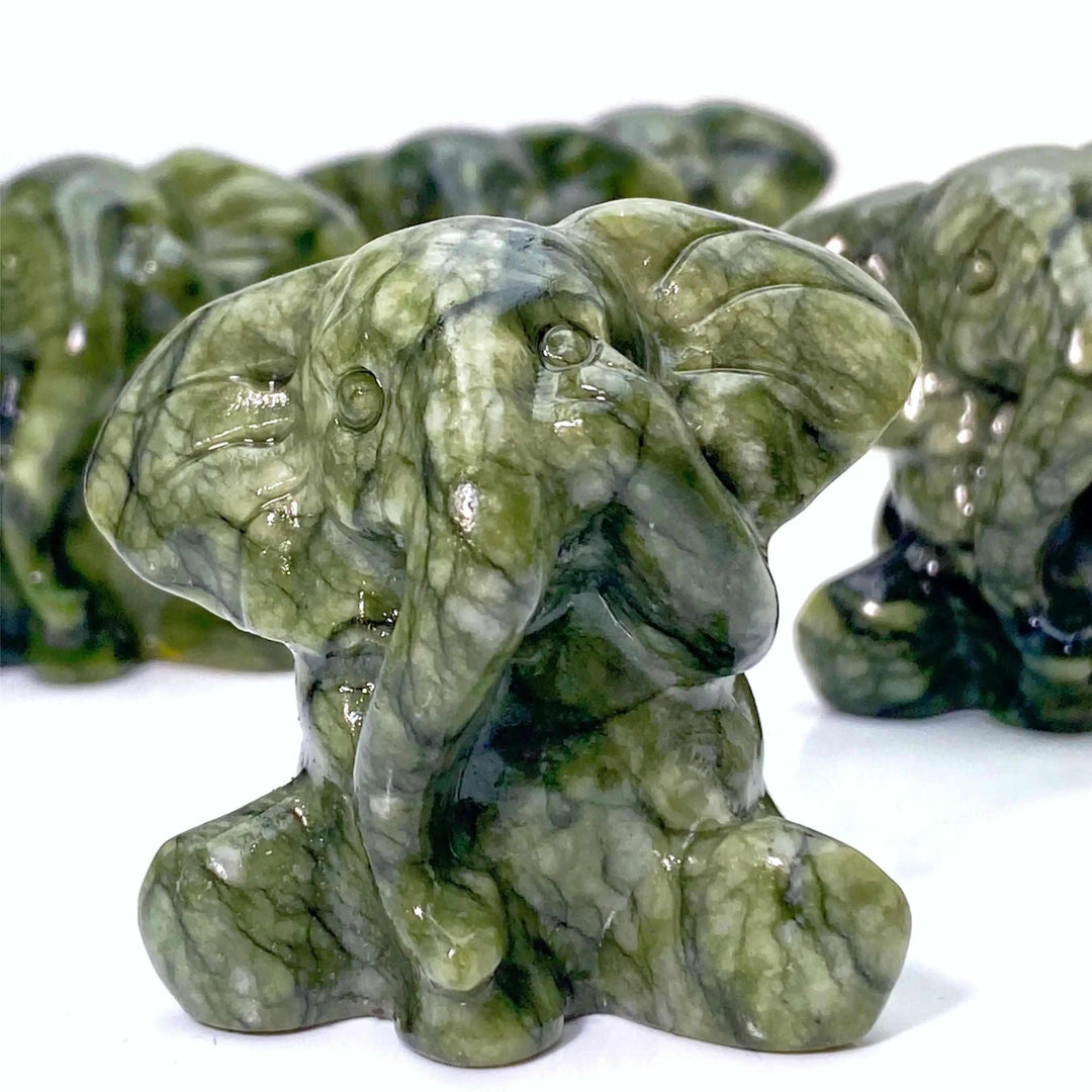 Xiuyan Jade Crystal Carved Elephant Statue: Deep green, waxy jade elephant for luck, wisdom, and protection.