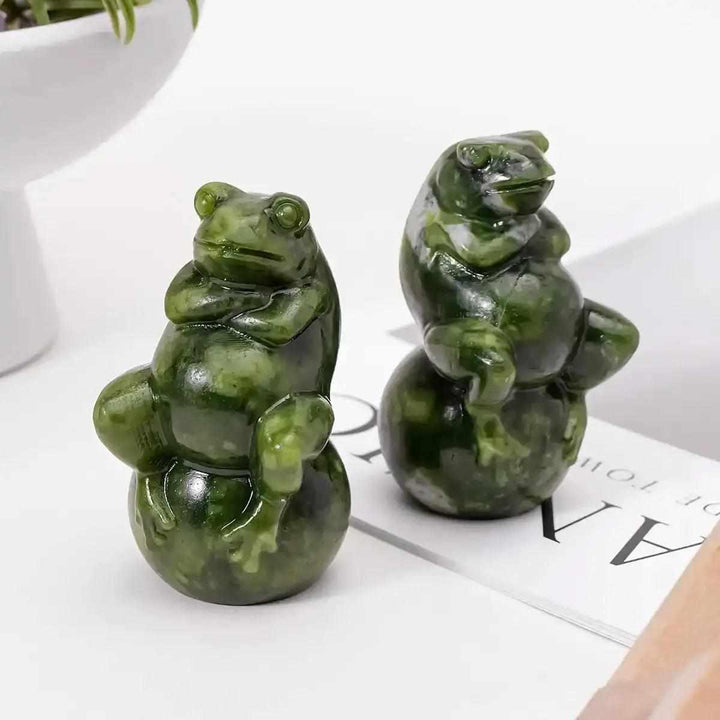 Polished Serpentine Jade frog carving on a ball, featuring mottled forest green tones for renewal and transformation.