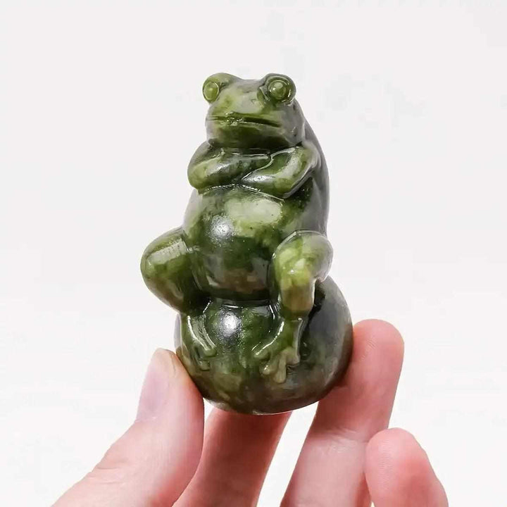 Hand-polished Serpentine Jade frog carving on a ball, featuring mottled forest green tones for renewal and transformation.