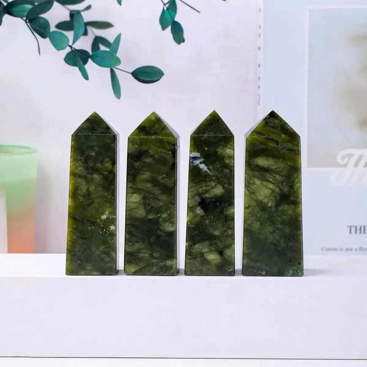 Four polished Serpentine Tower Points in mottled olive and deep green, perfect for Heart Chakra focus and decor.