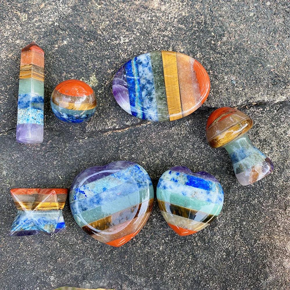 Seven Chakra Crystal Fused Polished Stone Collection: Vibrant, layered natural crystals in various shapes like hearts, wands, and spheres.