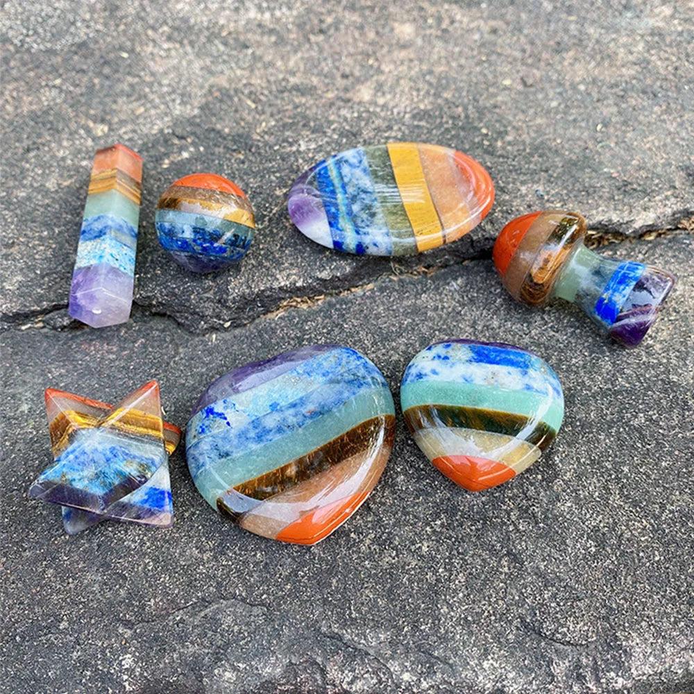 Polished Seven Chakra Crystal Fused stones in various shapes, showcasing vibrant layers of natural healing crystals.