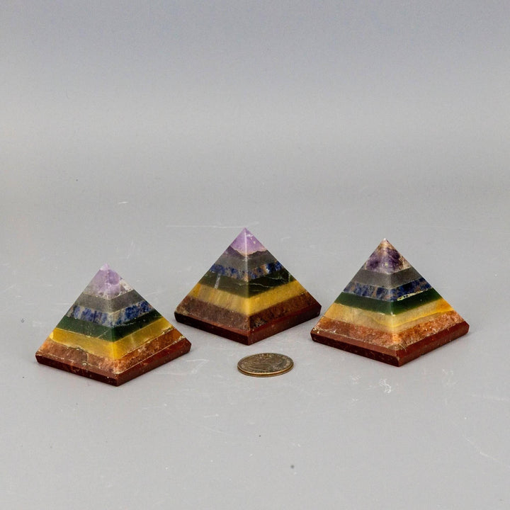 Three 7 Chakras Crystal Pyramids with stacked genuine gemstones, focusing combined energy for wellbeing.