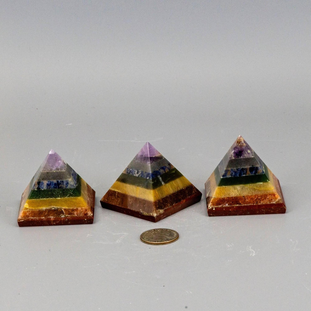 Three 7 Chakras Crystal Pyramids with stacked genuine gemstones, focusing combined energy for wellbeing.
