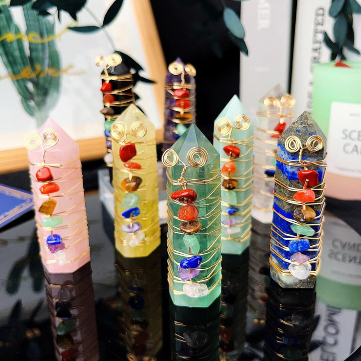 Colorful natural stone chakra crystal towers with copper wire winding, featuring rose quartz, amethyst, and other gemstones.