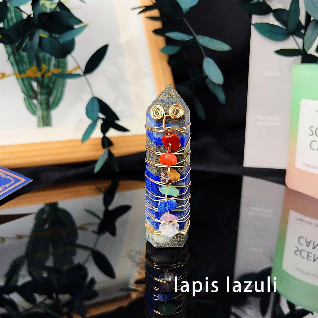 Lapis lazuli crystal tower with gold copper wire wrapping and seven chakra gemstone chips for energy healing.