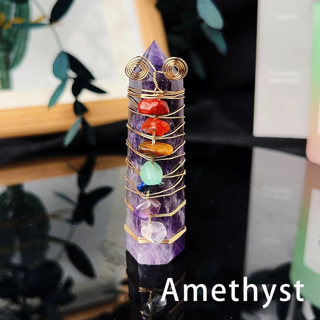 Amethyst tower with seven chakra crystal chips wrapped in gold copper wire, a natural energy gemstone craft.